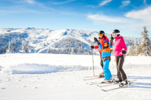 brightly dressed skiers in snowy mountain scene
